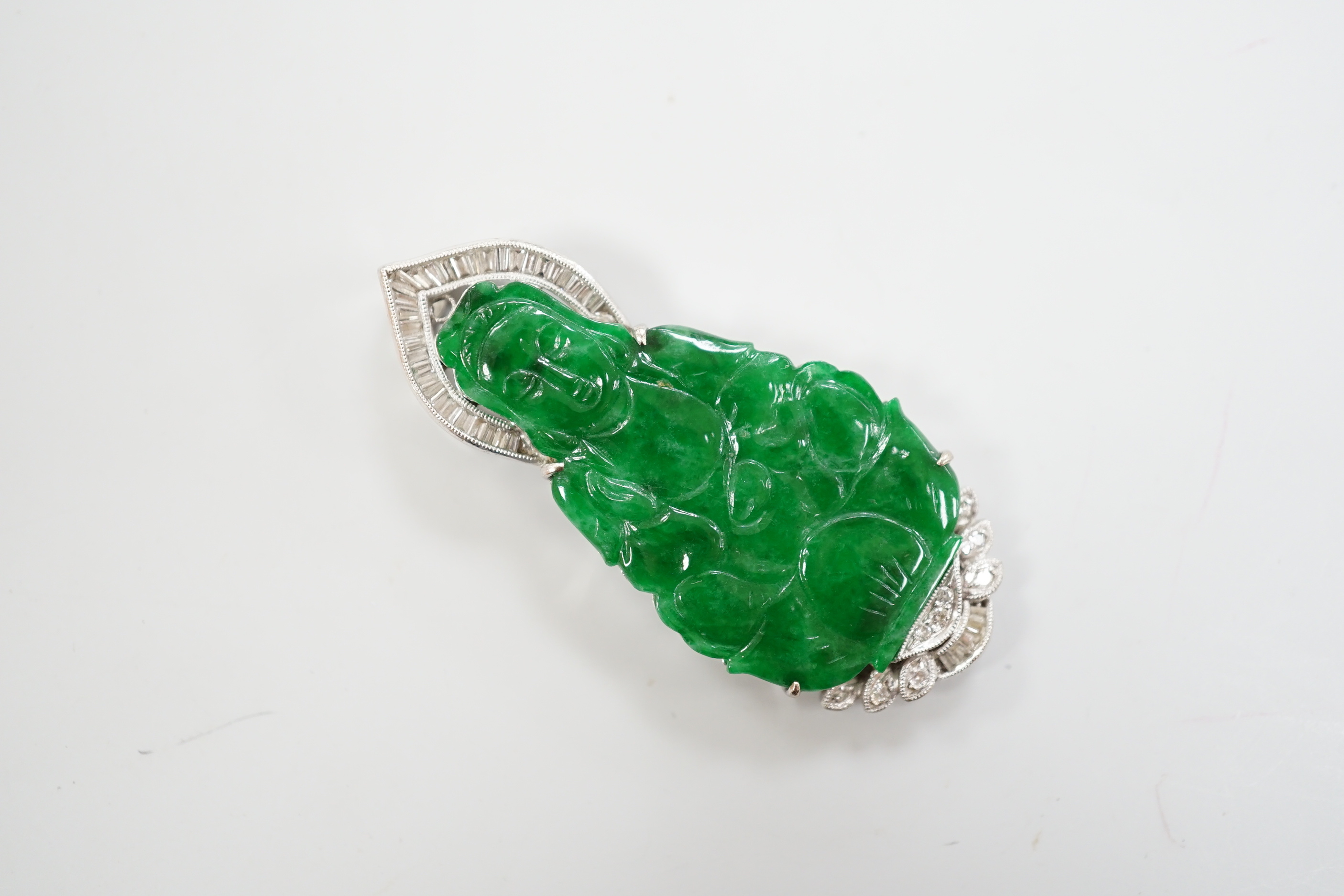 An 18k, baguette and round cut diamond cluster set carved jade figural pendant, the back with engraved hinged door, 47mm, gross weight 15.4 grams.